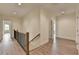 Upstairs hallway featuring luxury vinyl plank, neutral paint and access to bedrooms at 5533 Addison Woods Pl, Buford, GA 30518