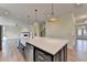 Kitchen island with white countertop, stainless steel dishwasher, and brass pendant lights at 5533 Addison Woods Pl, Buford, GA 30518
