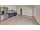 Stylish kitchenette with modern appliances, two-tone cabinetry, and access to an outdoor area at 5533 Addison Woods Pl, Buford, GA 30518
