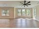 Open-concept living room with large windows providing an abundance of natural light at 5533 Addison Woods Pl, Buford, GA 30518
