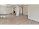 Open concept living room with wood floors, coffered ceiling, and elegant light fixtures at 5533 Addison Woods Pl, Buford, GA 30518