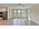 Open concept living area with large windows, stainless steel appliances, and breakfast bar at 5533 Addison Woods Pl, Buford, GA 30518