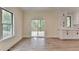 Bright living room with sliding glass doors to deck and large window at 5533 Addison Woods Pl, Buford, GA 30518