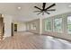 Spacious living room with laminate flooring and multiple windows offering scenic views at 5533 Addison Woods Pl, Buford, GA 30518