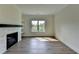 Cozy living room featuring a fireplace with white shelves and large windows at 5533 Addison Woods Pl, Buford, GA 30518