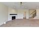 Spacious living room featuring hardwood floors, fireplace with marble surround and black mantel at 5533 Addison Woods Pl, Buford, GA 30518