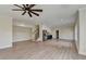 Expansive living area boasting laminate flooring, ample natural light, and staircase access at 5533 Addison Woods Pl, Buford, GA 30518