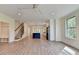 Bright, open-concept living room featuring hardwood floors, staircase, and a modern kitchen with an island at 5533 Addison Woods Pl, Buford, GA 30518