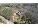 Aerial view of a home surrounded by trees, on a corner lot near main thoroughfare at 5642 N Highway 212, Covington, GA 30016
