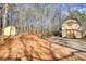 Exterior view of the barn and adjacent shed surrounded by a grove of mature trees at 5642 N Highway 212, Covington, GA 30016