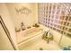 Bathroom featuring a jacuzzi bathtub, glass block window, and unique decor at 5642 N Highway 212, Covington, GA 30016