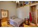 Cozy bedroom featuring wood floors, unique shelving, and rustic decor at 5642 N Highway 212, Covington, GA 30016