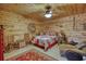 Cozy bedroom with wood paneled walls, ceiling fan and a decorative rug at 5642 N Highway 212, Covington, GA 30016