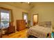 Comfortable bedroom with wood floors, windows with a view, and rustic wooden furniture at 5642 N Highway 212, Covington, GA 30016