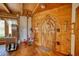 Unique entryway featuring a custom wood door, wood floors, and intricate woodworking details at 5642 N Highway 212, Covington, GA 30016