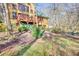 Property showcasing a backyard with trees, brick pathways, and a deck at 5642 N Highway 212, Covington, GA 30016