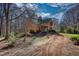 A charming stone house with a metal roof, blossoming trees, and landscaped yard at 5642 N Highway 212, Covington, GA 30016