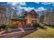 Charming two-story home with a landscaped yard, a green roof, and eye-catching windows at 5642 N Highway 212, Covington, GA 30016