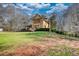 Charming two-story home with a landscaped yard, a green roof, and eye-catching windows at 5642 N Highway 212, Covington, GA 30016