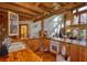 Bright and spacious kitchen featuring wood floors, wooden beams, and views of the living area at 5642 N Highway 212, Covington, GA 30016