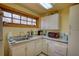 A bright kitchenette including white cabinetry and granite countertops with a red microwave at 5642 N Highway 212, Covington, GA 30016