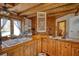 Rustic kitchen featuring wood floors, wooden beams, butcher block countertops, and a view to the backyard at 5642 N Highway 212, Covington, GA 30016