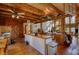 Open kitchen featuring wood floors, wooden beams, kitchen island and bright natural light at 5642 N Highway 212, Covington, GA 30016