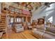 Open-concept living area with wood floors, wooden beams, loft area, and comfortable seating at 5642 N Highway 212, Covington, GA 30016