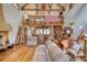 Bright and airy living room with exposed wooden beams, wood floors, a fireplace, and a loft area at 5642 N Highway 212, Covington, GA 30016
