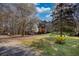 Expansive front yard with mature trees and the home in the background at 5642 N Highway 212, Covington, GA 30016