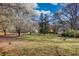 Expansive front yard with mature trees and the home in the background at 5642 N Highway 212, Covington, GA 30016