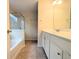 Bathroom featuring a combination tub and shower, and a vanity at 11780 Wellsley Way, Alpharetta, GA 30005