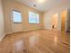 Bedroom featuring hardwood floors, a window, and a door to the exterior and bathroom at 11780 Wellsley Way, Alpharetta, GA 30005