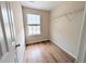 Walk-in closet with hardwood flooring, a window, and shelving for storage at 11780 Wellsley Way, Alpharetta, GA 30005