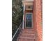 Inviting brick front porch with black front door and black hand railing at 11780 Wellsley Way, Alpharetta, GA 30005