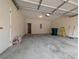 Spacious garage with concrete floors, paint cans, and a ladder at 11780 Wellsley Way, Alpharetta, GA 30005