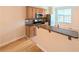Well-lit kitchen with bar seating and stainless steel appliances at 11780 Wellsley Way, Alpharetta, GA 30005