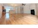 Open-concept living space featuring hardwood floors, fireplace, and neutral paint at 11780 Wellsley Way, Alpharetta, GA 30005