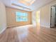Large primary bedroom featuring a trey ceiling, hardwood floors, and ample natural light at 11780 Wellsley Way, Alpharetta, GA 30005