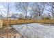 Gravel backyard surrounded by a new wooden fence with budding trees and the shadows of larger trees overhead at 733 Cherokee Se Ave, Atlanta, GA 30315