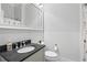 Well-lit bathroom featuring a dark granite countertop and decorative mirror at 733 Cherokee Se Ave, Atlanta, GA 30315