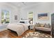Bright bedroom featuring hardwood floors and natural light from the windows at 733 Cherokee Se Ave, Atlanta, GA 30315