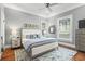 Bright bedroom with a ceiling fan, large bed, and hardwood floors at 733 Cherokee Se Ave, Atlanta, GA 30315