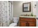 Bathroom featuring granite vanity, floral shower curtain, and tile floors at 1850 Westwind Dr, Cumming, GA 30041