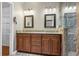 Main bathroom features double sink vanity with granite counters and tiled glass shower at 1850 Westwind Dr, Cumming, GA 30041