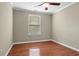 Bedroom with hardwood floors, ceiling fan, and one window at 1850 Westwind Dr, Cumming, GA 30041