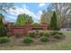 Welcoming brick entrance to Westwind neighborhood featuring mature trees and manicured landscaping at 1850 Westwind Dr, Cumming, GA 30041