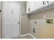 Laundry room with white cabinets and door to garage at 1850 Westwind Dr, Cumming, GA 30041