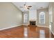 Bright living room with hardwood floors, fireplace, vaulted ceiling, and large windows at 1850 Westwind Dr, Cumming, GA 30041