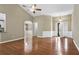 Bright living room with hardwood floors, ceiling fan, and arched entryway at 1850 Westwind Dr, Cumming, GA 30041